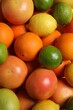 © New Africa - Different fresh citrus fruits as background, top view