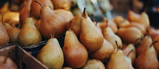 Sticker - A cluster of ripe pears neatly displayed on a wooden table at a market stall. The pears are varied in size and color, showcasing their natural textures and shapes.