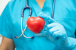 © amazing studio - Doctor holding a red heart in hospital ward, healthy strong medical concept.