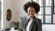 © supachai - afro-american adult female smiling, wearing formal modern suit clothes with neutral
