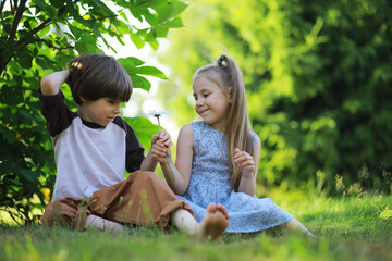 Wall Mural - Children walk in the summer in nature. Child on a sunny spring morning in the park. Traveling with children.