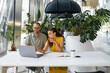 © Artem Podrez/Stocksy - A young man and a woman work together using a laptop