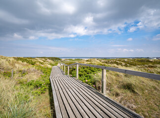 Wall Mural - wooden boardwalk along the dune landscape near rantum, sylt, schleswig-holstein, germany