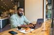 © Pedro Merino/Stocksy - Focused Man working with laptop in a coffee shop