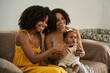 © Edward Córdoba / Andréas Sichel/Stocksy - Mother, daughter, and grandmother watching the TV screen