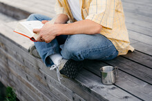 A man reads a book outdoors