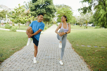 Wall Mural - Happy diverse couple doing leg stretch exercise before morning run