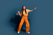 © deagreez - Full length photo of brunette charming model girl with disco ball makes rhythm dynamic dance moves isolated on dark blue color background