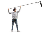 Full length shot of audio operator holding a microphone on set