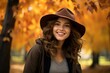 © juliars - Smiling girl autumn park. Pretty woman in fall yellow season. Generate ai