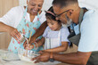 © Wavebreak Media - Biracial grandparents and their granddaughter are baking together in a kitchen
