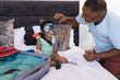© Wavebreak Media - Grandfather helps his young granddaughter try on snorkeling gear in a bedroom