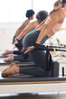 © Wavebreak Media - Women engage in a Pilates class at a fitness studio on reformers