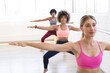 © Wavebreak Media - Young Caucasian woman leads a barre class at a bright studio