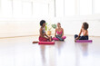 © Wavebreak Media - Three women relax after a yoga session in a bright studio with copy space