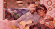 Image of hearts over happy diverse couple playing guitar