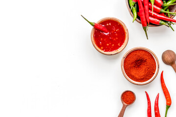 Wall Mural - Dry powder and fresh red and green chilli pepper as food ingredient on white table background top view mockup