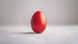 Solitary red Easter egg centered against a clean, minimalist background.