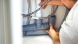 Fototapeta  - Close up plumber hands repair plumbing pipes in kitchen sink. Removing blockage clog in drain pipe. Replacement of plumbing pipes