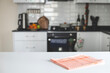 Checkered towel on the table in the kitchen. space for text