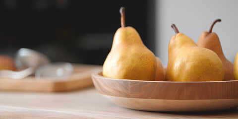 Poster - Pears in a bowl on the kitchen table on a blurred background