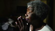 Devout Christian Senior African American woman in PRAYER at home, close-up face of one black elderly lady in her 80s closing eyes in deep meditation, HOPE and FAITH