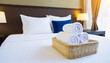 © netsay - Fresh towels on bed in hotel room