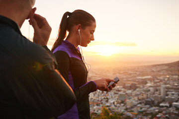 Poster - Couple, fitness and music with phone in sunset for podcast, radio player or sound on mountain. Man and woman listening to audio or streaming before workout, exercise or outdoor training in nature