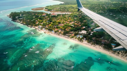 Wall Mural - Airplane wing view over tropical beach, turquoise water