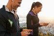 © Katie/peopleimages.com - Earphones, phone and couple outdoor for fitness, music choice for workout and runner team with tech. Cardio, health and listening to radio with scroll on app, sports and motivation for exercise
