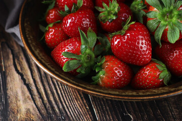 Wall Mural - A bowl with ripe bright strawberry in rustic style	