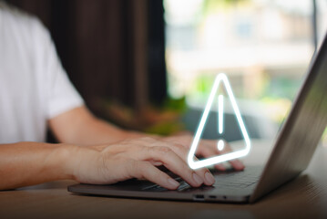 Caution failure system hacked warn alert concept. Businessman use computer laptop, triangle caution warning sign for cyber notification error, trouble maintenance. Available internet cybersecurity .