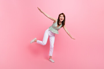 Sticker - Full length photo of adorable good mood girl having fun flying open hands isolated on pink color background