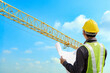© Kwangmoozaa - construction engineer worker in protective helmet and blueprints paper on hand at building site background