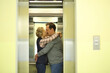 © Pavel Losevsky - Man with a mustache and woman hugging and kissing in the lift