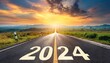 © blackdiamond67 - New year 2024 Text 2024 written on the road in the middle of asphalt road.