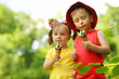 © Pavel Losevsky - Happy little boy and girl eat sweet ice cream in green summer park