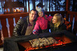 © Pavel Losevsky - Father, mother and daughter near the brazier with barbecue on a winter evening