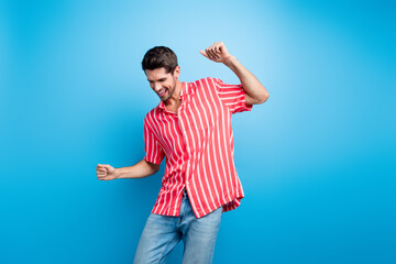 Sticker - Photo of satisfied pleasant man with bristle trendy haircut dressed striped shirt dancing have fun isolated on blue color background