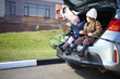 © Pavel Losevsky - Two children are sitting in open trunk with fishing rod and net