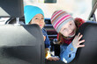 © Pavel Losevsky - Happy little boy and girl sitting inside the car