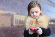 © Pavel Losevsky - Pretty little girl dials a phone number on street