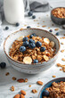 granola with berries and nuts for breakfast, in a bright kitchen