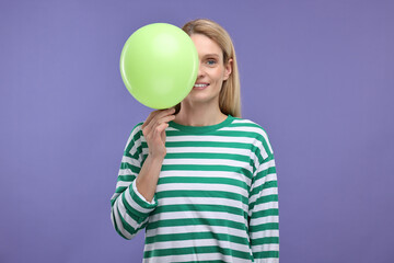 Wall Mural - Woman with air balloon on violet background