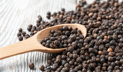 Wall Mural - black pepper on wooden spoon