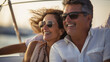 © dvoevnore - Smiling caucasian middle age couple enjoying leisure sailboat ride in summer