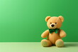 © Milan - Bear toy with a bowtie on plain green studio background. Photo of plush teddy bear with copy space for text. Patrick's Day and Birthday present concept background banner