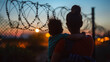 Silhouettes of a Latino Woman and Child at the Border. Emigration Crisis on the Mexico-America Border. Immigration Theme.