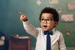 Excited young child with curly hair, wearing glasses and a bow tie, points at something off camera, his eyes wide with amazement