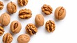 Top-down view of isolated walnut kernels on a white background.